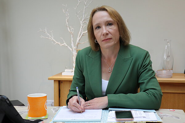 Helen writing at her desk