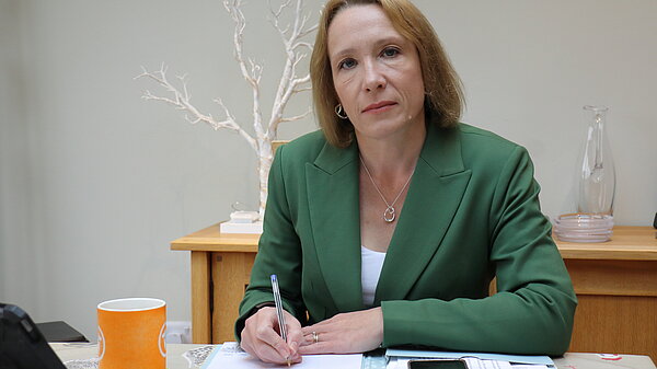 Helen writing at her desk