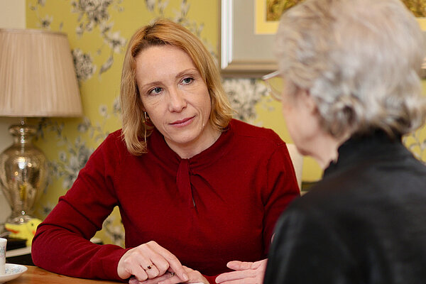 Helen talking with a local pensioner