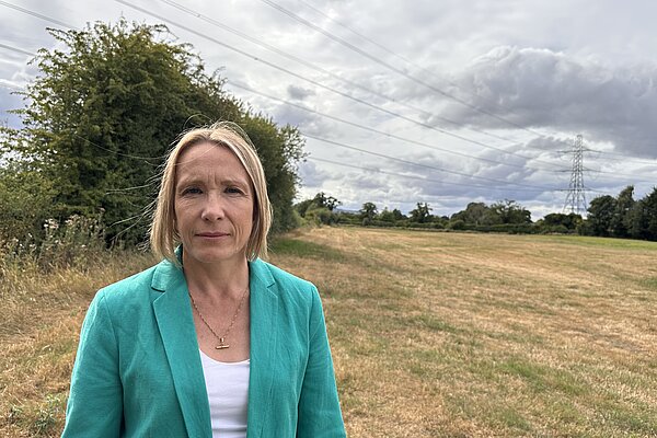 Helen stands in front of the beautiful countryside that would be used for the huge substation