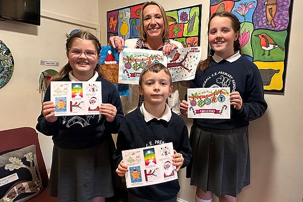 Helen Morgan MP with the winner and runners up of this year's Christmas card competition