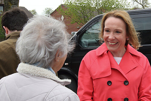 Helen hearing from a local pensioner