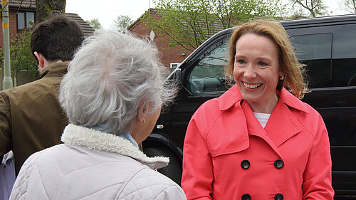 Helen hearing from a local pensioner