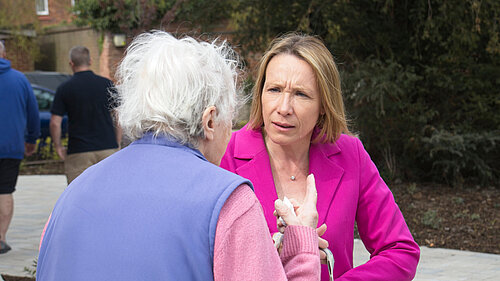 Helen speaking to a very concerned pensioner