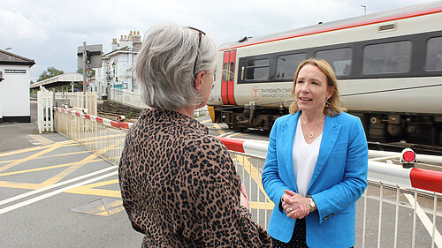 Helen with local trains running behind her