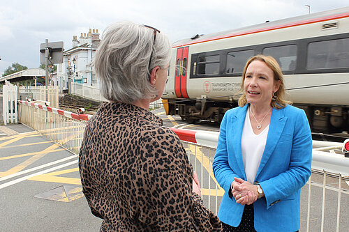 Helen with local trains running behind her