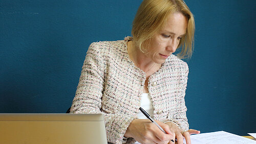 Helen working in her office